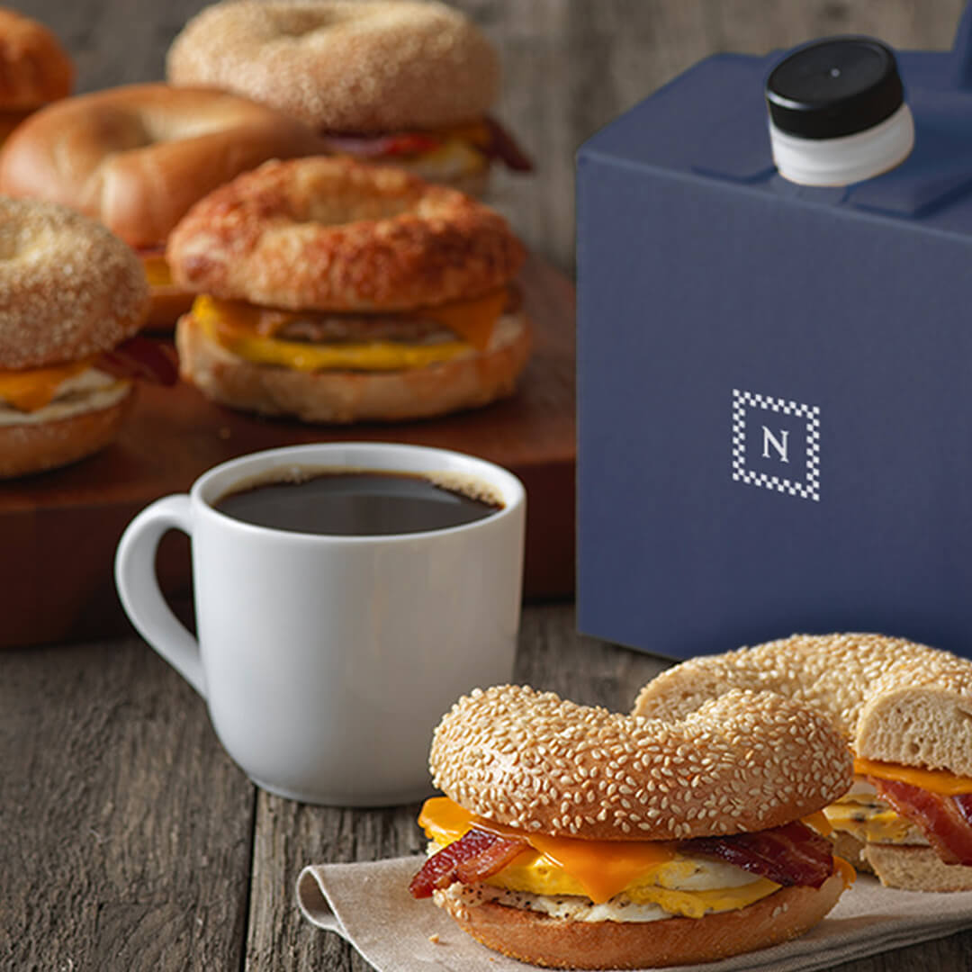 image of a breakfast bagel sandwich and hot coffee from Noah’s NY Bagels